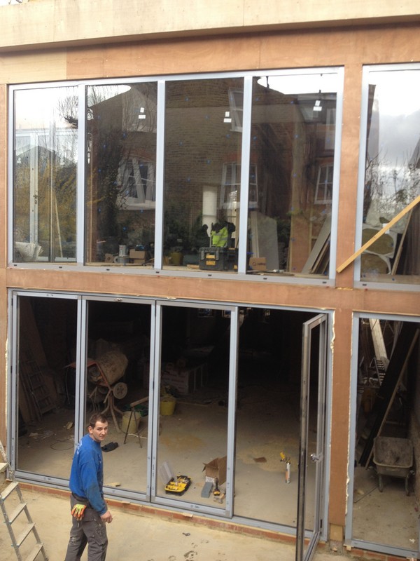 Aluminium bi-fold doors with two-storey glazing in Lee