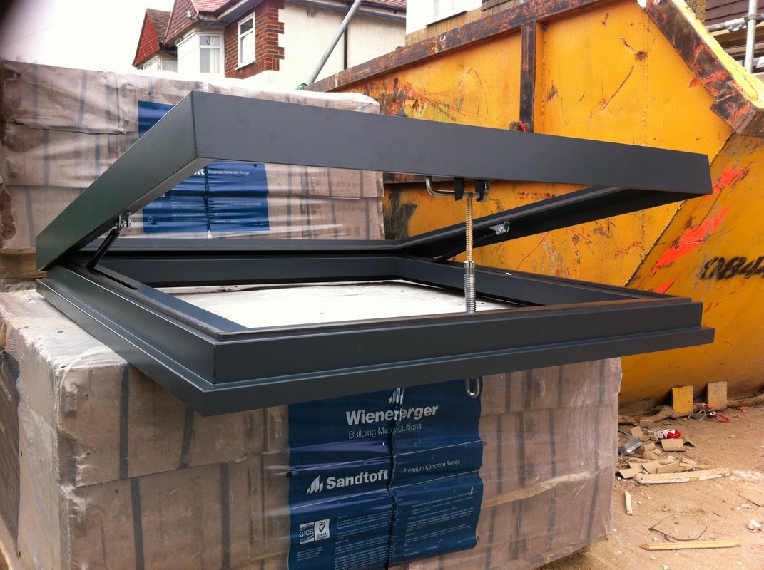 Opening flat roof skylight in anthracite grey installed in Lee