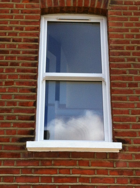 uPVC sash window on Victorian red brick house in Lee